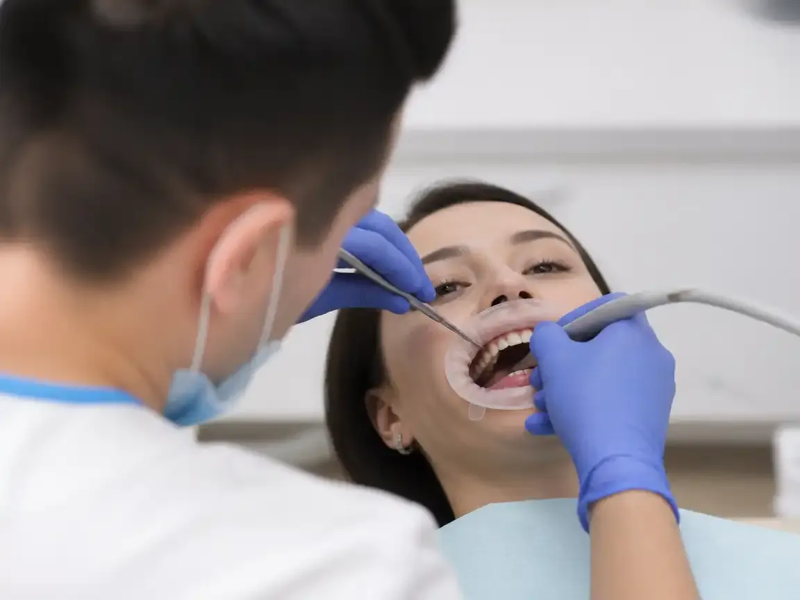 The treatment stage itself: the doctor's gloved hands working inside the oral cavity — an illustration for the "Scanning" section