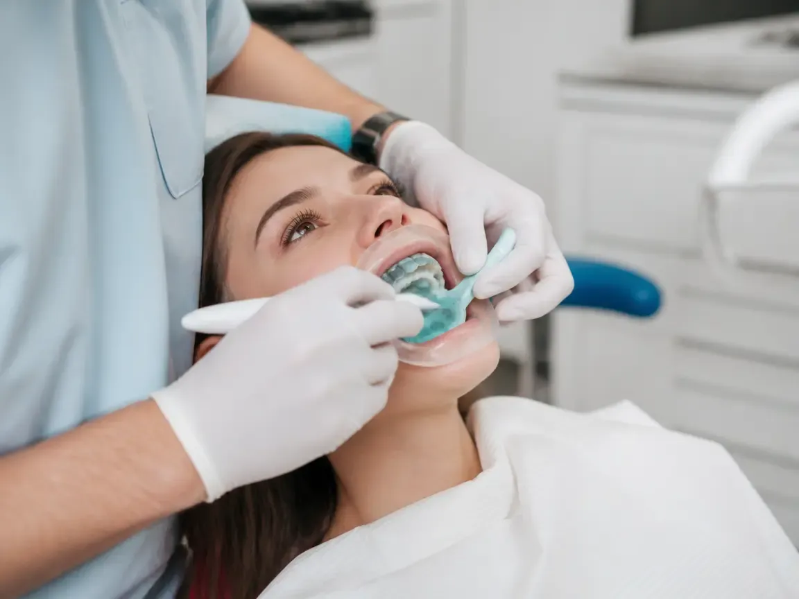 The treatment stage itself: the doctor's gloved hands working in the oral cavity — an illustration for the "Framework fabrication" section