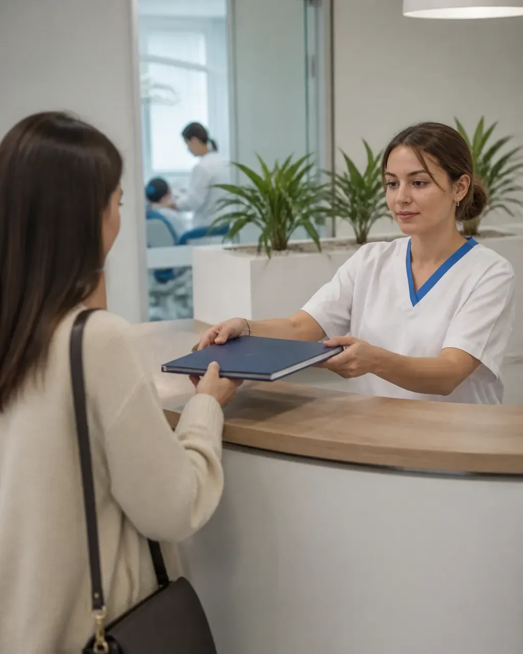 The clinic administrator gives the patient a treatment plan at the front desk