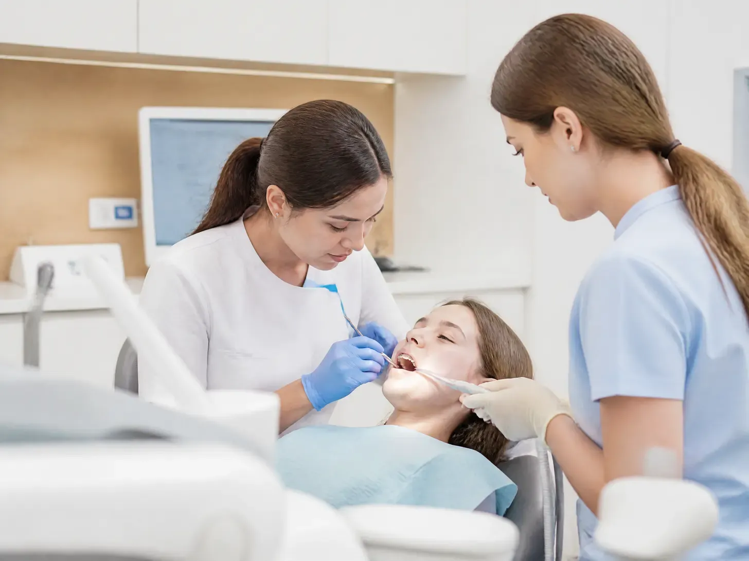 forestadent braces — doctor shows the patient a treatment plan on a screen in a bright office