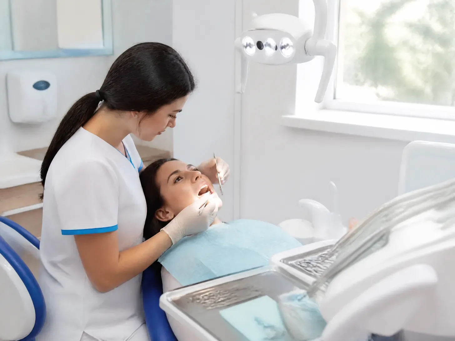 gingivitis treatment cost — dentist showing a patient a treatment plan on a screen in a bright office