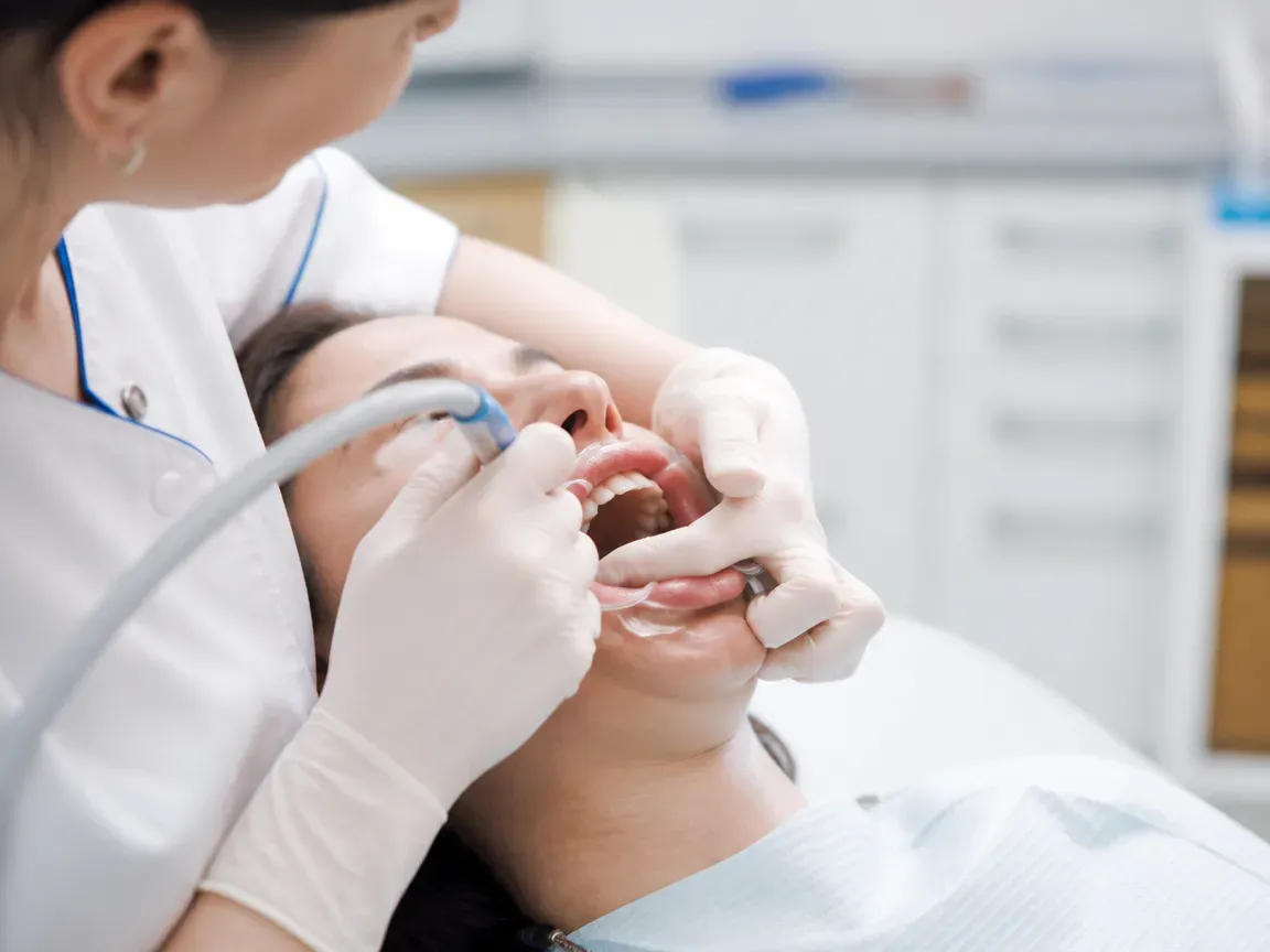 The treatment stage itself: the doctor's gloved hands working inside the oral cavity — an illustration for the "Healing period" section