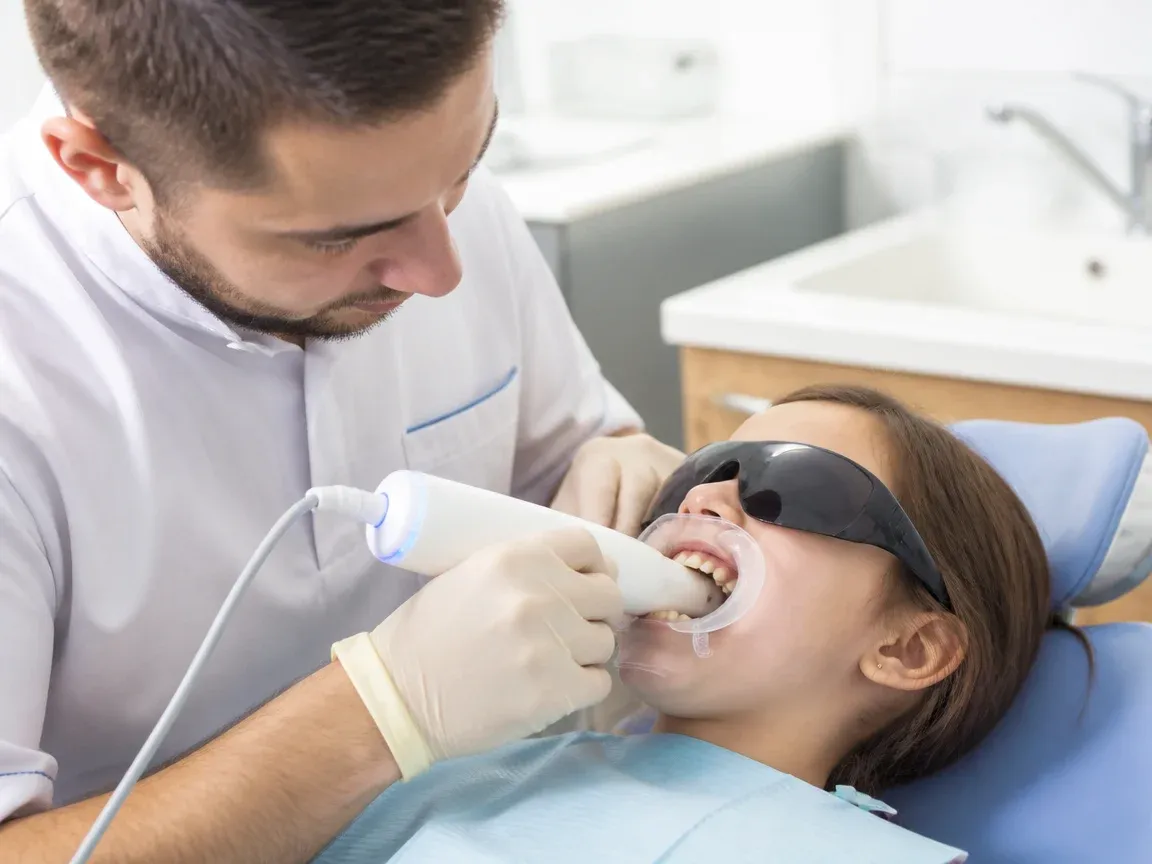 The treatment stage itself: the doctor's gloved hands working in the oral cavity — an illustration for the section “Step 3: Taking impressions”