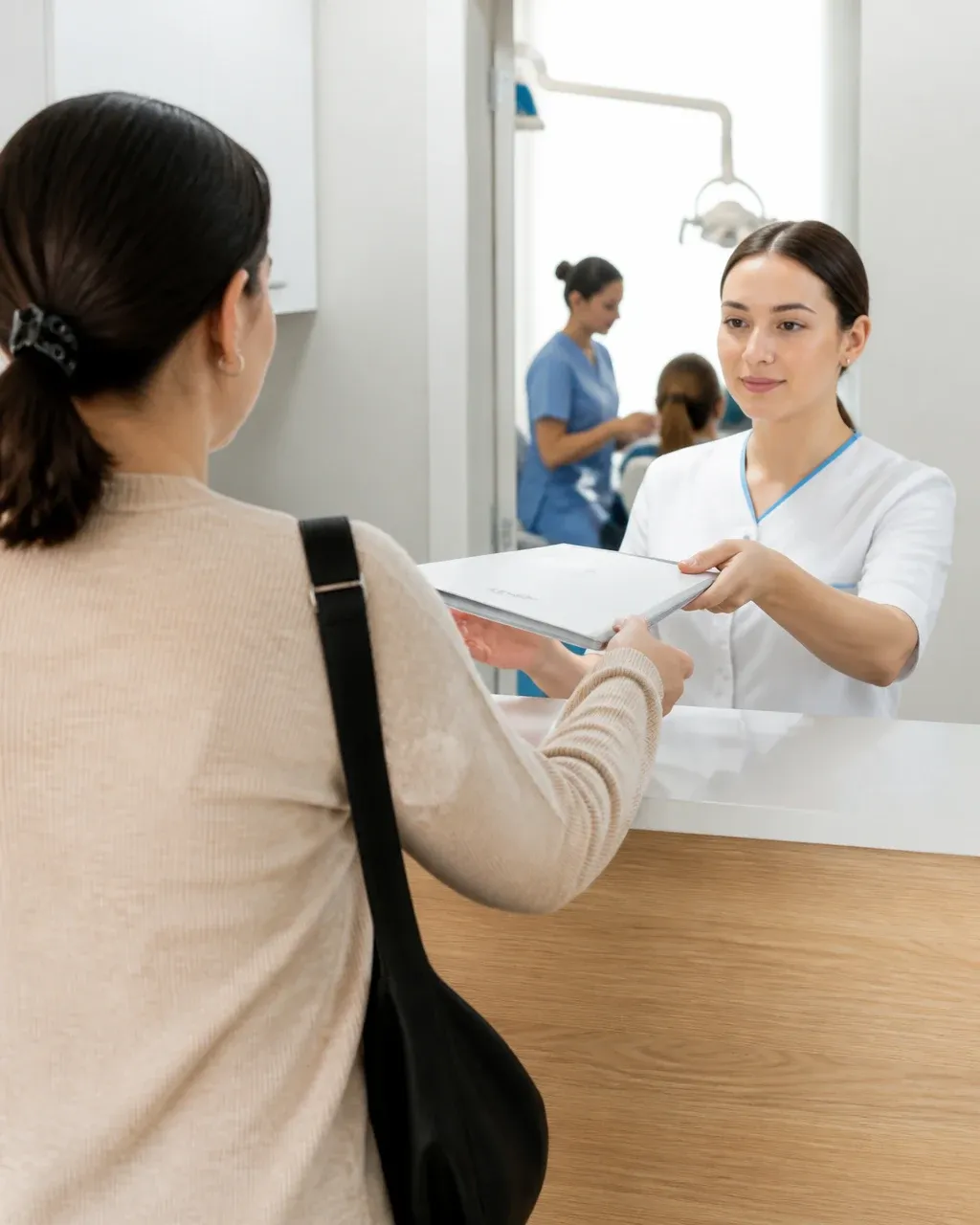 The clinic administrator gives the patient a treatment plan at the front desk