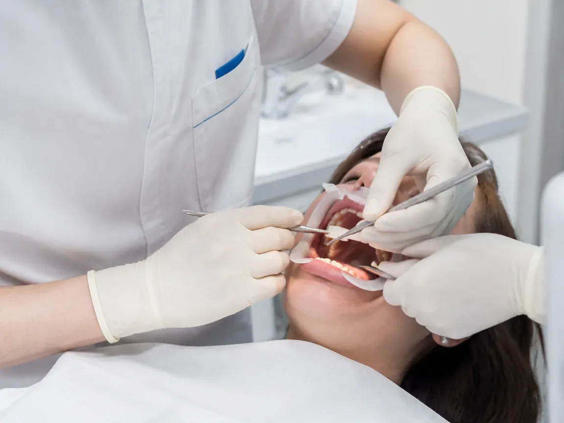 The treatment stage itself: the doctor's gloved hands working inside the oral cavity — an illustration for the "Surgical Stage" section