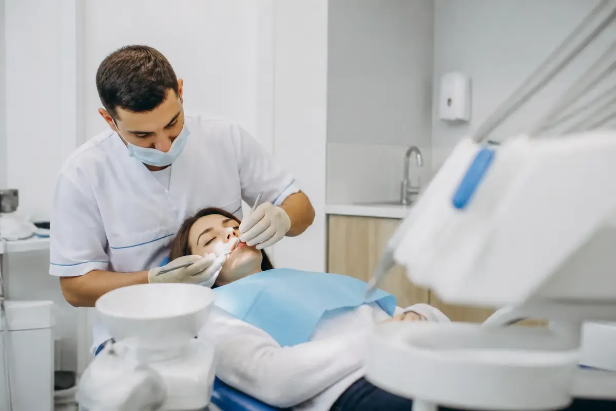 Chairside appointment: dentist at work, over-the-shoulder shot of the assistant — illustration for the Intravenous Sedation section
