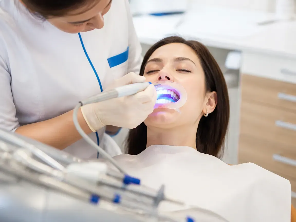 The treatment stage itself: the doctor's gloved hands working inside the oral cavity — an illustration for the section "Application of the composition and exposure"