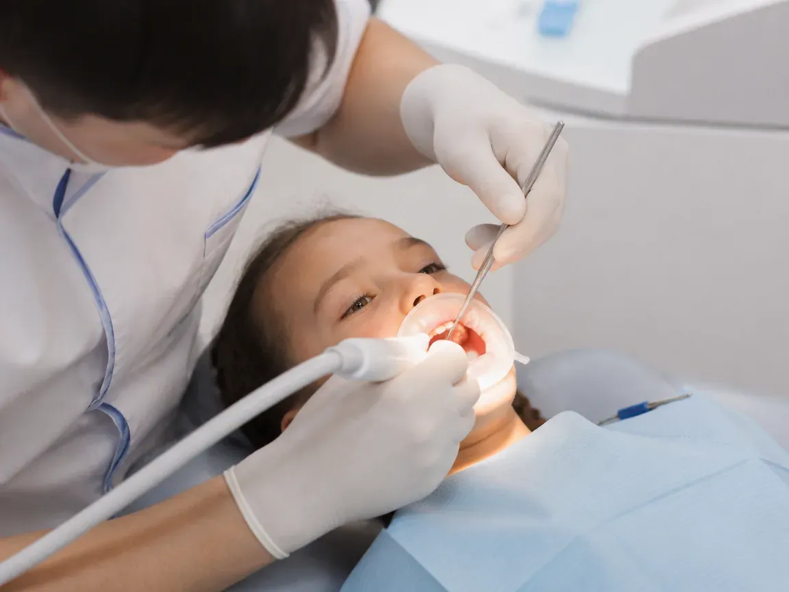 The treatment stage itself: the doctor's gloved hands working inside the oral cavity — an illustration for the "Laser Treatment" section