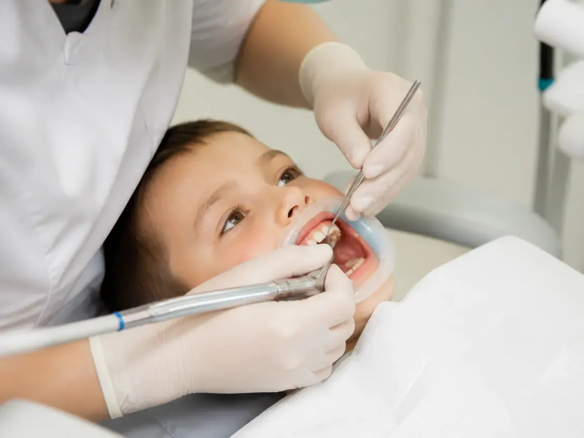 The treatment stage itself: the doctor's gloved hands working inside the oral cavity — an illustration for the section "Post-procedure follow-up"