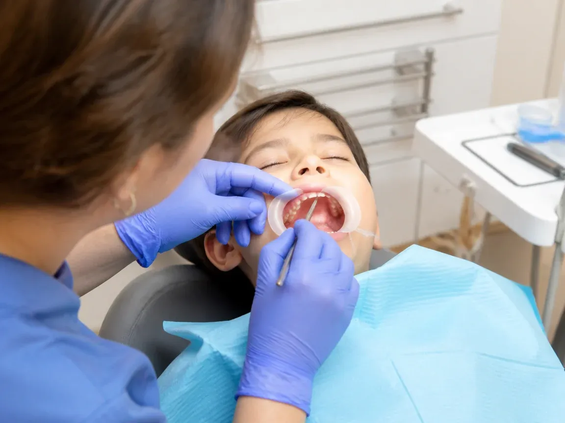 The treatment stage itself: the doctor's gloved hands working in the oral cavity — an illustration for the "Performing the Procedure" section