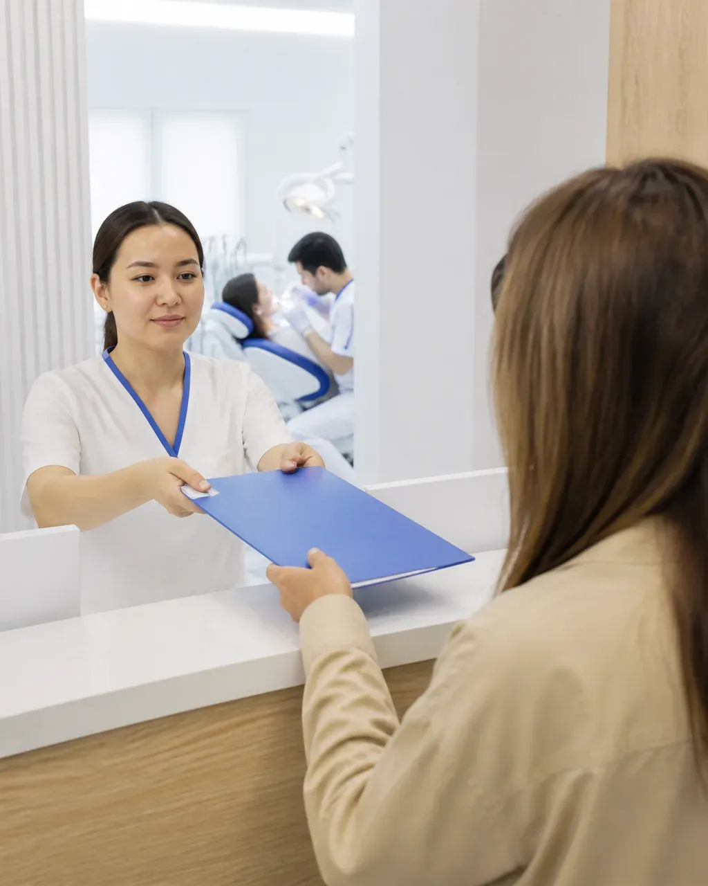 The clinic administrator gives the patient a treatment plan at the front desk