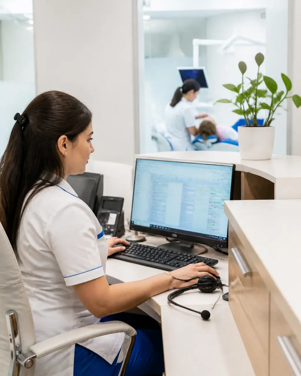 The clinic administrator answers patient messages at the front desk