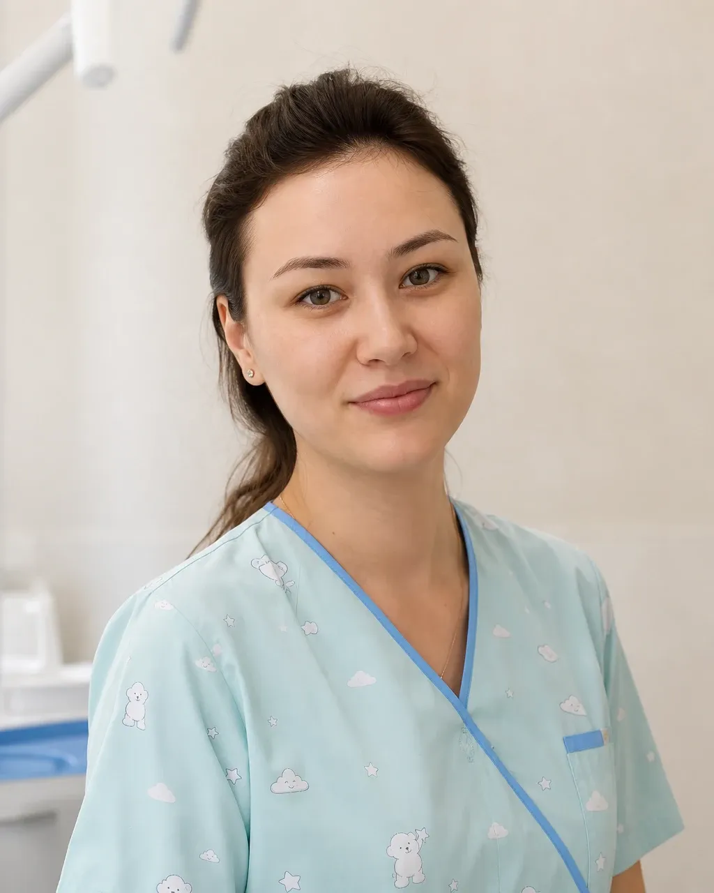 Байжанова Айсұлу Нұрланқызы — Алматыдағы Dental-Center стоматологиялық клиникасының дәрігері, жұмыс киіміндегі портреті