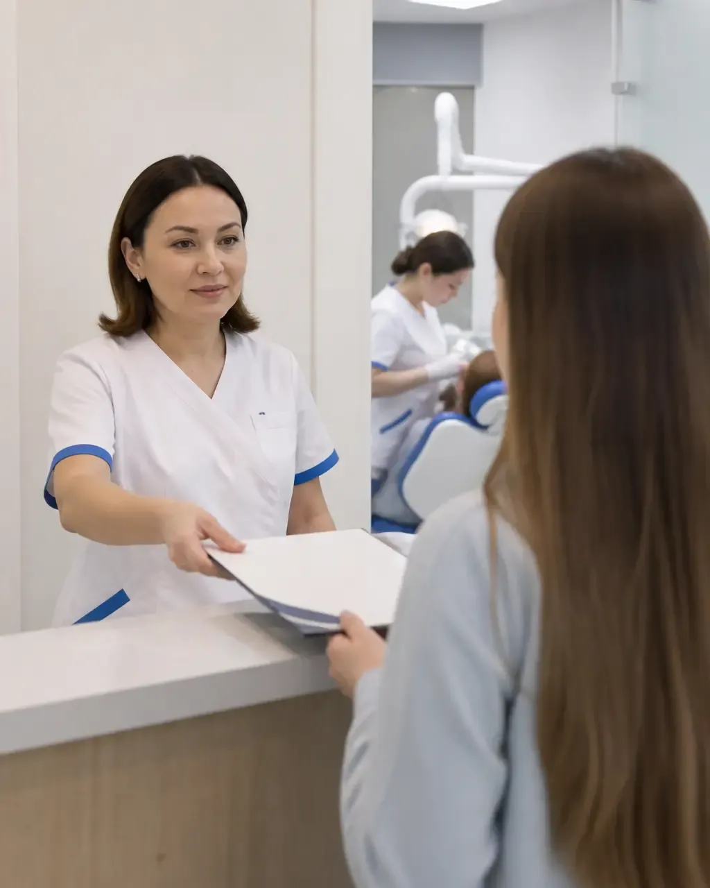 The clinic administrator gives the patient a treatment plan at the front desk