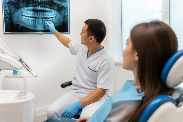 Doctor shows the patient an image on the screen and explains the treatment plan — illustration for the "Care and Products" section